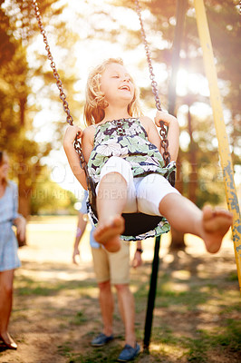 Buy stock photo Happy, parent and girl in park on swing, having fun and bonding on summer break. Smile, freedom and family in playground with sunshine, safety and childhood development in springtime getaway. 