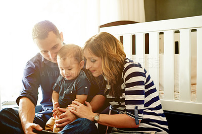 Buy stock photo Family, toddler and watching with phone for entertainment or childhood development in home. Mom, dad or people with mobile smartphone, child or boy for fun engagement or bonding together in nursery