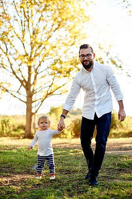 Buy stock photo Father, child walking and holding hands at park for support, care and bonding together on vacation. Happy dad, kid and toddler outdoor in nature for love, travel and girl on holiday with parent