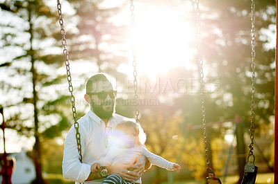 Buy stock photo Sunshine, swing and dad with child in park for playing, fun and bonding on weekend in nature. Happy, family and father with girl on playground for relationship, holiday and adventure together outdoor