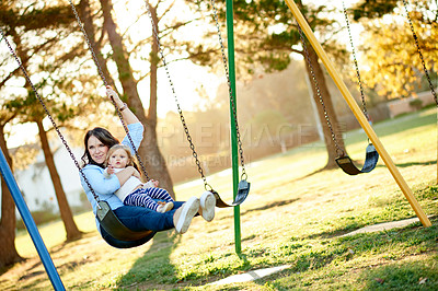 Buy stock photo Swinging, mother and girl in park, fun ride and bonding together with happiness, love and nature. Family, outdoor and parent with mama, relax and child development in playground, games and care
