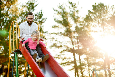 Buy stock photo Nature, slide and father with child in park for holiday, weekend or vacation together. Smile, sunshine and girl kid with dad for playing outdoor on playground for connection or bonding in summer.