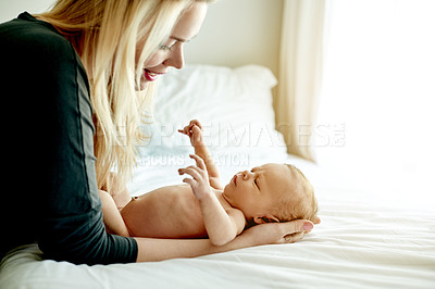 Buy stock photo Relax, love and mother with baby on bed for bonding, care and family time in home together. Happy, security and newborn child with mom in bedroom for support, safety and protection in apartment.