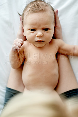 Buy stock photo Newborn, above and hands of parent in nursery with bonding, serious face and head support. Family house, people and early child development with connection or protection, safety and baby at home