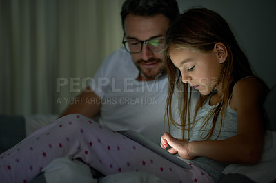 Buy stock photo Night, father and child in bedroom with tech for digital app, playing educational games or bonding. Late, parent and daughter in home with tablet for reading ebook, watching video or bedtime story.