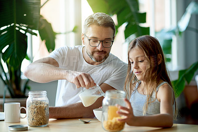 Buy stock photo Breakfast, milk or morning with father and daughter in dining room of home together for meal. Cereal, love or pouring with girl child and single parent man in apartment for family bonding on weekend
