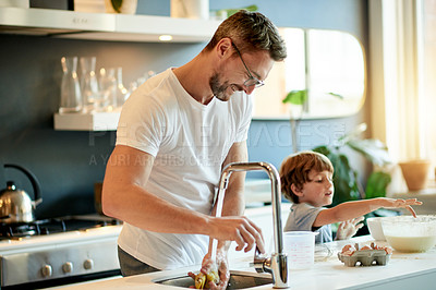 Buy stock photo Happy man, child and cooking at kitchen sink with ingredients, cleaning and preparation for baking. Mature father, son and smile in home with eggs, bonding and connection for homemade snack.