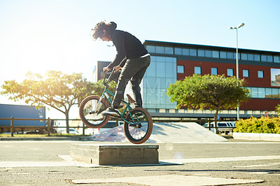 Buy stock photo Man, bicycle and jump for outdoor activity, hobby or challenge in skate park. Bike, person and urban sport for cycling, BMX training and skills for competition with balance and stunt exercise