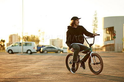 Buy stock photo Urban, relax and man on bicycle for thinking, training and travel in city street to chill on break. Cool male person, morning or stunt biker in town for biking, wellness or outdoor cycling at sunset