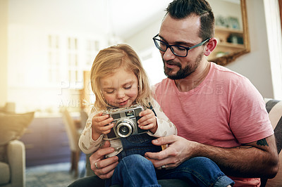 Buy stock photo Digital, camera and man with child, lounge and photography with daughter on weekend, retro and home. Teaching, girl or pictures with vintage tech, growth and kid with skill development, dad and hobby
