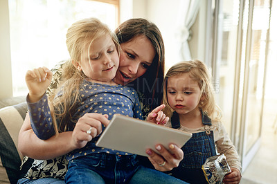 Buy stock photo Tablet, relax and mother with girl children on sofa in living room of home for development. App, browsing or elearning with single parent woman and daughter kids in apartment together for growth