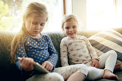 Buy stock photo Tablet, portrait and children on sofa in home for playing educational game on app for learning. Digital technology, bonding and girl kids with online entertainment together in living room at house.