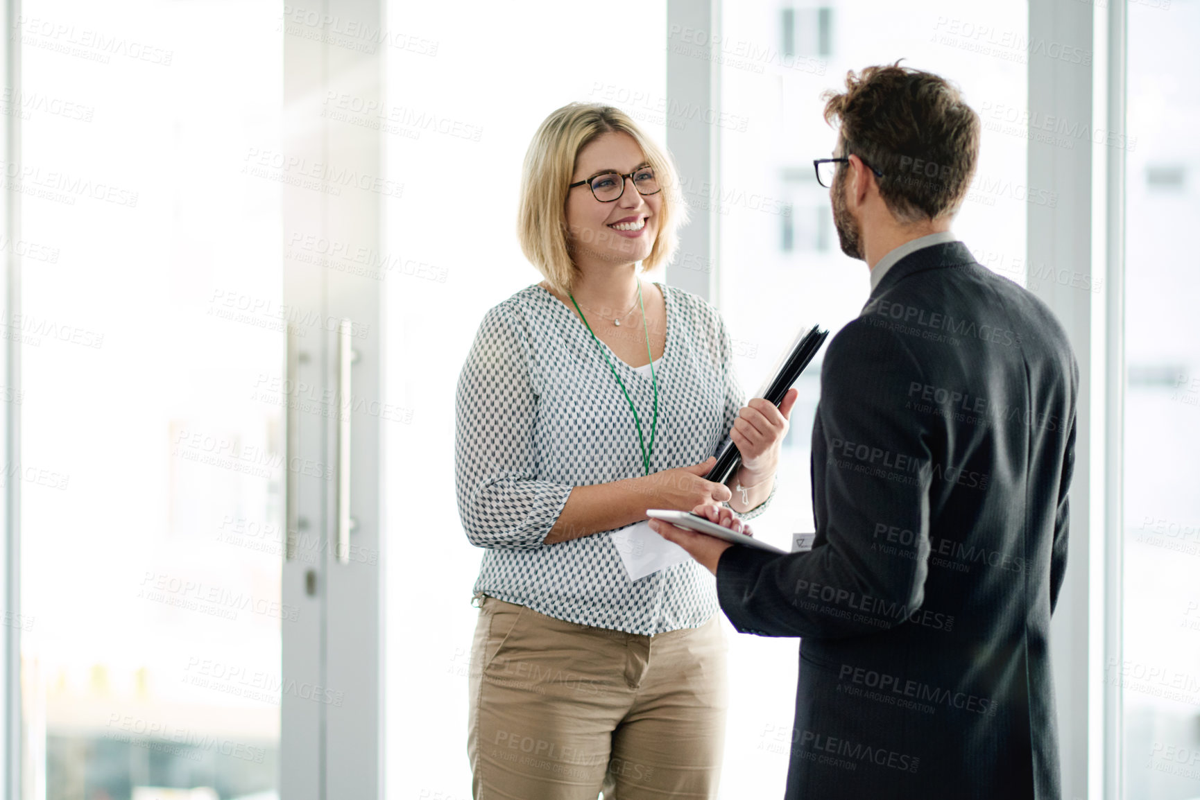 Buy stock photo Happy, manager and employee at window with tablet for feedback review, communication and project collaboration. Digital app, discussion and people in workplace with tech, teamwork or strategy meeting