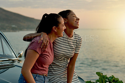 Buy stock photo Shot of two young women enjoying a road trip