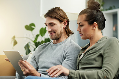Buy stock photo Moving day, relax and tablet with couple on sofa in living room of new home for growth or investment. App, boxes and planning with people in apartment together for mortgage or property purchase