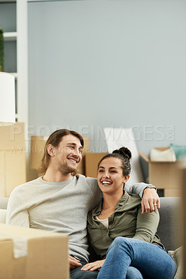 Buy stock photo New home, boxes and couple hug on sofa to relax after moving, relocation and real estate purchase. Space, bonding and man with woman with embrace, love and support for property, mortgage and house