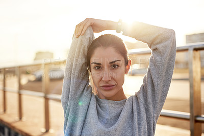 Buy stock photo Fitness, portrait and woman stretching in city for healthy body, wellness or prepare at sunset. Warm up arm, face and female runner outdoor for training, exercise or determination for sports marathon