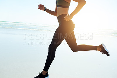 Buy stock photo Legs, woman and running for fitness on beach for exercise, training and endurance routine. Space, female person and jogging with blue sky, sports workout and marathon practice on ocean for wellness