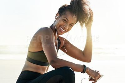 Buy stock photo Portrait, athlete and woman with earphones, beach and music for training routine, break and fitness. Outdoor, runner and black person with tech for audio, rest and workout with smartphone in nature