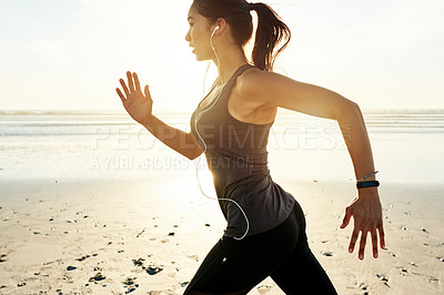 Buy stock photo Fitness, running and woman on beach with music, sunrise and commitment to healthy outdoor workout. Earphones, training and girl at ocean for morning exercise, body wellness and jogging in nature.