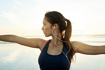 Buy stock photo Woman, earphones and beach yoga at sunset for balance, calm and peaceful mindset in zen nature. Warrior pose, music and wellness frequency tone for mental clarity, stretching and body movement by sea