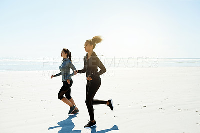 Buy stock photo Fitness, friends and running on beach for exercise, wellness or cardio training with space. Women, runners and challenge at ocean for competitive workout, endurance or marathon practice together