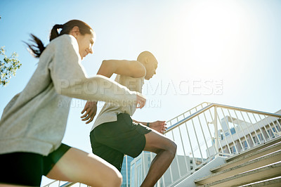 Buy stock photo Fitness, friends and running in city for health, body wellness and training in low angle. Team, cardio and people exercise outdoor on steps for workout, sport and race with energy for performance