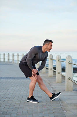 Buy stock photo Mature man, stretching and workout on promenade by sea with warm up for exercise, health or fitness in morning. Person, outdoor and start routine for running, training and legs by ocean in Italy
