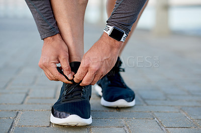 Buy stock photo Man, athlete and tie shoelace by sea, sports preparation and outdoor for marathon training. Male person, sneakers and getting ready for cardio challenge on beach promenade, runner and start workout