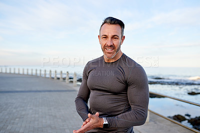 Buy stock photo Mature man, runner and portrait on promenade by ocean, break or pride with smile for workout in morning. Person, training and fitness by sea with confidence, happy or outdoor for exercise in Spain