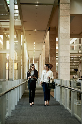 Buy stock photo Discussion, team and business women walking with tablet for architecture or progress update. Talk, meeting and architect in hallway for planning project, building development and bokeh in office