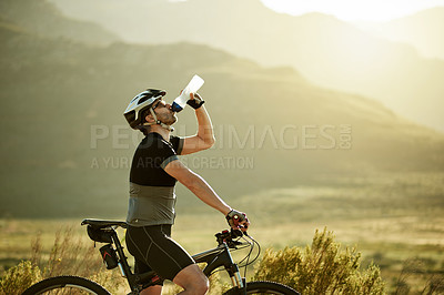 Buy stock photo Drinking water, fitness and bicycle with man in nature for health, hydration and cardio workout. Electrolytes drink, sports and cycling training with person and space outdoor for triathlon practice