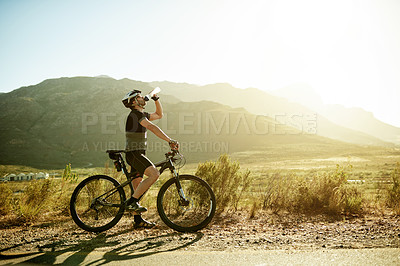 Buy stock photo Drinking water, travel and bicycle with man in nature for health, hydration and cardio workout. Electrolytes drink, sports and cycling training with person and space outdoor for triathlon practice