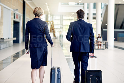 Buy stock photo Walking, back and suitcase with business people in airport for conference trip, networking and team. Partnership, international destination and commute with employees in lobby for travel and coworker