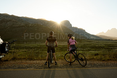 Buy stock photo Morning, mountain and back of couple on bicycle for sports hobby, outdoor exercise and workout. Sunrise, flare and man with woman on bike in countryside for cycling, wellness and fitness in nature