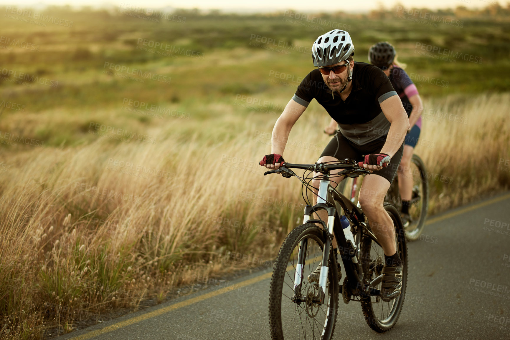 Buy stock photo Cycling, road and couple with bicycle outdoor for hobby, training and fitness in nature for race. Sports, trip and woman with man on bike with helmet for exercise, journey or challenge in countryside