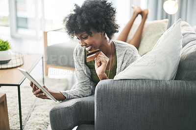 Buy stock photo Credit card, relax and black woman on tablet on sofa for online shopping, payment and digital order. Happy, home and person on tech with bank info for website sale, discount and ecommerce purchase