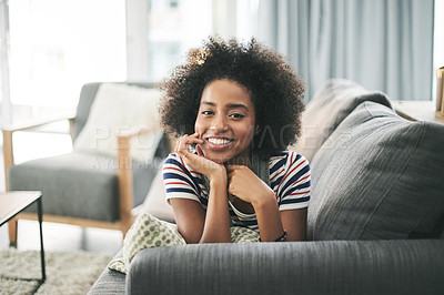 Buy stock photo Black woman, smile and portrait on sofa in house with off day, weekend or rest in living room. Happy, female person and relax on couch for break in lounge, stress relief or comfortable in apartment