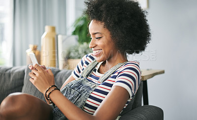 Buy stock photo Phone, smile and typing with woman on sofa in living room of home for online post or update. App, communication and text message with happy African person in apartment for download or mobile chat