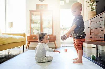 Buy stock photo Home, living room and baby children play with toys for bonding, quality time and child development. Family, siblings and kids playing with building blocks for learning, educational games and fun