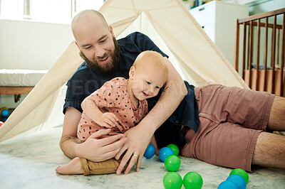 Buy stock photo Baby, father and play with balls in home by tent, having fun and bonding together. Child, care and dad playing with toys with happy infant, toddler and kid enjoying quality family time in house.