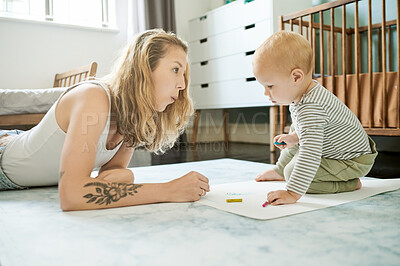 Buy stock photo Baby, mama and learning drawing on paper in home, bonding and coloring. Education, art and mother teaching child for creative development, growth and homeschool, homework and knowledge in house.