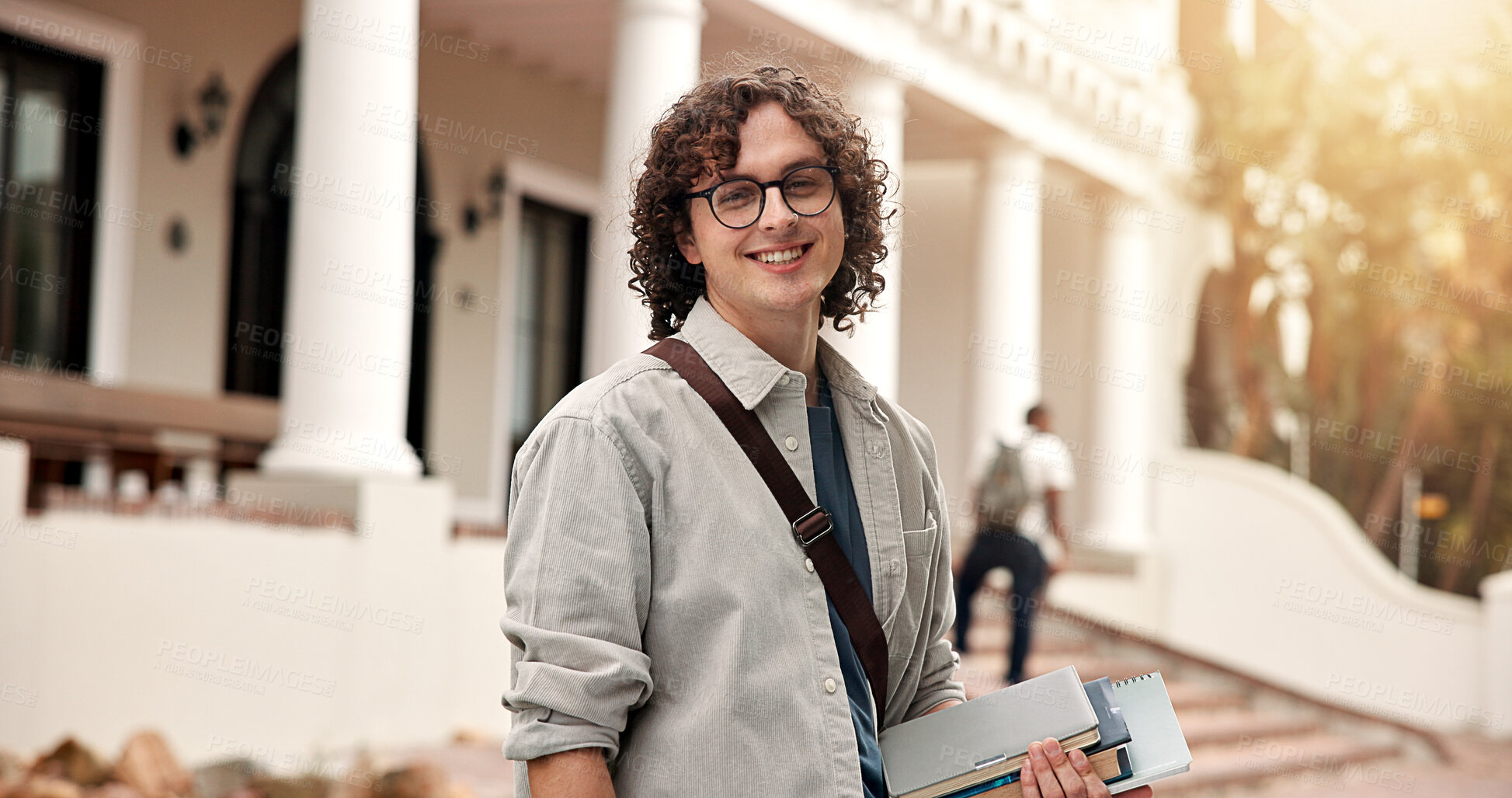 Buy stock photo Portrait, man and student at campus with smile, exchange program and scholarship for education. Happy, male person and confident at university with books, start semester and learning for knowledge