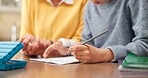 Homework, grandparent and child in house with hands, childcare and support with homeschool activity. Education, grandmother and kid with task help, family guidance and assistance in home learning.