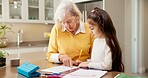 Homework, grandmother and girl in kitchen with help, childcare and support with homeschool activity. Education, grandparent and kid with task aid, family guidance and assistance in home learning.