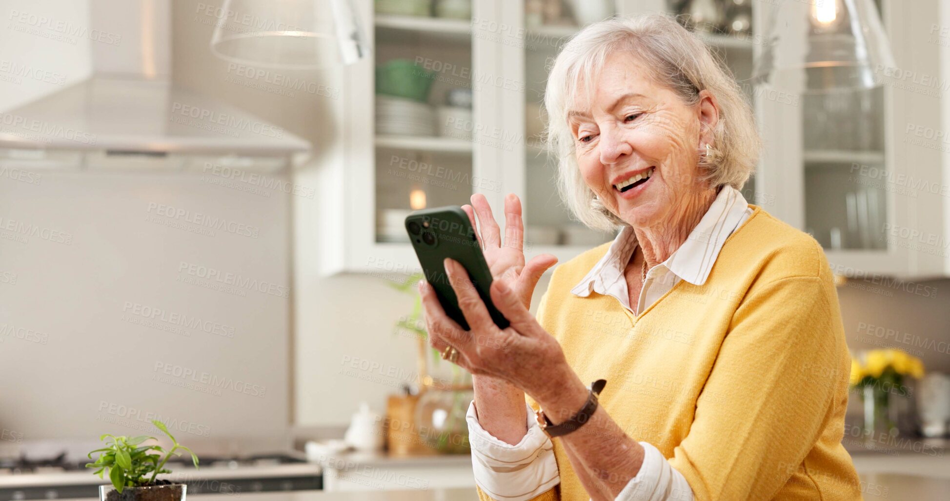 Buy stock photo Phone, wave and old woman in home with video call, social media and online meeting on weekend break. Happy, senior person and greeting in kitchen with tech, network and hello for virtual contact.