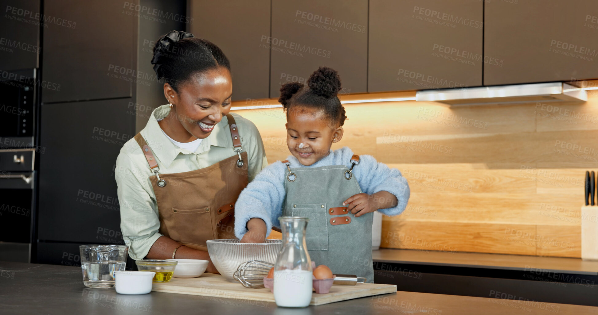 Buy stock photo Mother, child and baking in kitchen with smile, teaching daughter and playful with happiness. Black family, parent and girl with flour on nose at home for learning cooking with bowl, bonding or funny