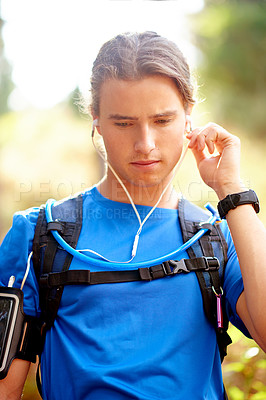 Buy stock photo Fitness, man and thinking in nature with music, playlist or audio track for motivation. Runner, break or outdoor with earphones for streaming podcast, connectivity or training ideas on media platform