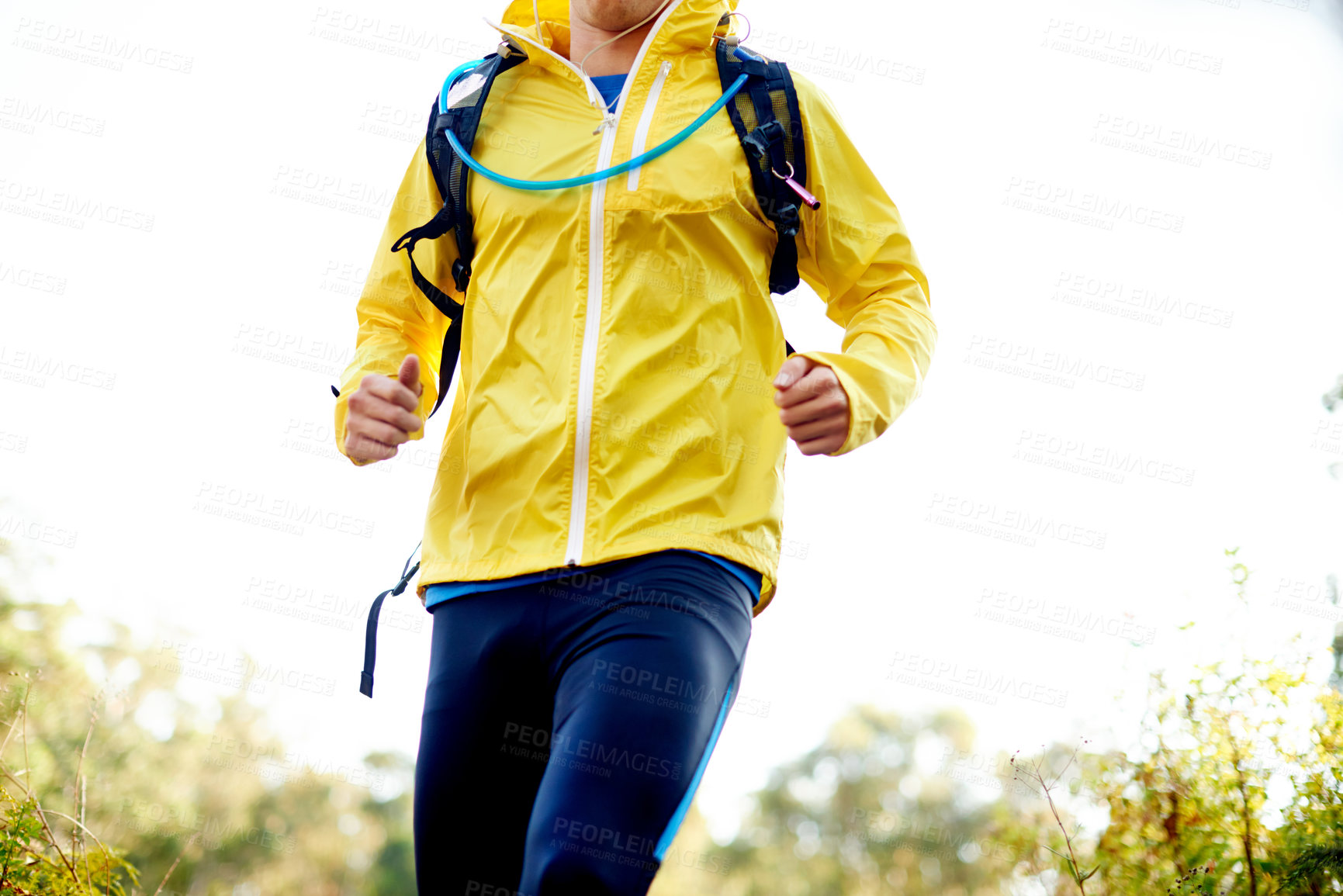 Buy stock photo Running, athlete and person with backpack, outdoor and cardio for fitness in environment and wellness. Sportswear, body and runner with energy for health, speed or training for performance in woods
