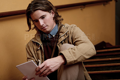 Buy stock photo Man, student and reading with tablet on stairs for online research, study or social media app. Male person, academic or scholar with technology for digital course, ebook or knowledge in college